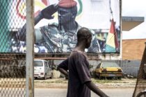 A man walks past a billboard showing junta leader, Colonel Mamady Doumbouya, in Conakry on September 11, 2021. Doumbouya's special forces on September 5, 2021 seized Alpha Conde in a Coup, the West African state's 83-year-old president, a former champion of democracy accused of taking the path of authoritarianism.